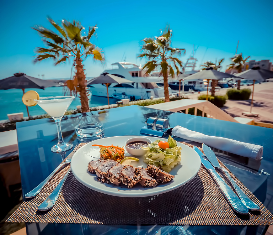 Seaside dining with salad and drink.